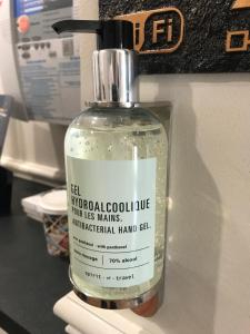 a bottle of therapeutic hand gel sitting on a counter at Hôtel De La Cathédrale in Reims