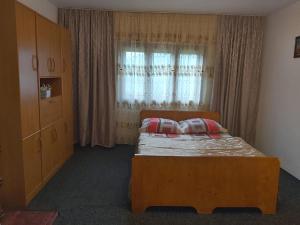 a bedroom with a bed in front of a window at Casa Geo in Arieşeni