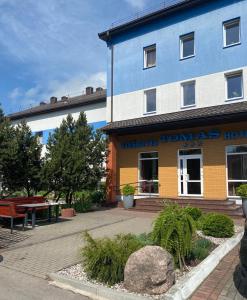 a building with a sign that reads werkannis hotel at Hotel Tomas in &Scaron;iauliai