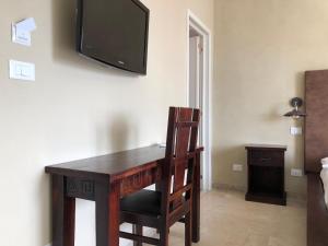 TV a/nebo společenská místnost v ubytování L'Attico di Piazza Mazzini Rooms
