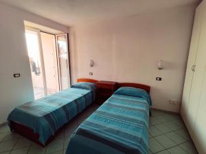 3 łóżka w pokoju z oknem w obiekcie Casa De Somma w mieście Ischia