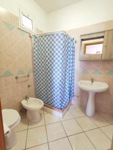 a bathroom with a toilet and a sink and a shower at Casa De Somma in Ischia