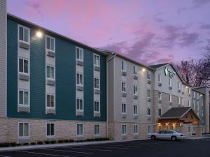 a building with a car parked in front of it at LikeHome Extended Stay Hotel Columbus in Columbus