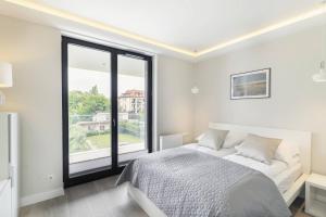 Posteľ alebo postele v izbe v ubytovaní Grand Apartments