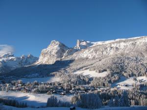 a ski resort in the mountains with snow on it at Residence Rosarela in Badia