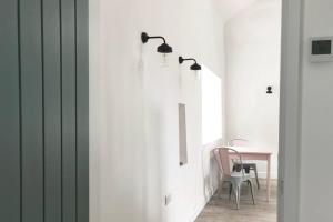 a dining room with a table and a white wall at North Wales Cottage Views, Walks, Dogs Welcome in Cilcain +5 photos