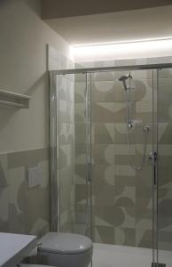 a bathroom with a glass shower with a toilet at Hotel Ondina e Milazzo in Cervia