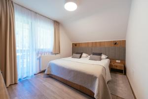 a bedroom with a bed and a large window at Penzion Livada in Kranjska Gora +30 photos