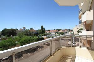 a balcony with a view of a city at Soleil Bleu - T2 classé 3 étoiles en front de mer in Canet-en-Roussillon +7 photos