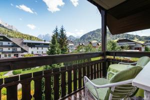 a balcony with chairs and a view of mountains at Penzion Livada in Kranjska Gora