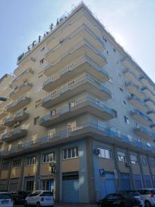 a large building with cars parked in front of it at RosAmar in Bari