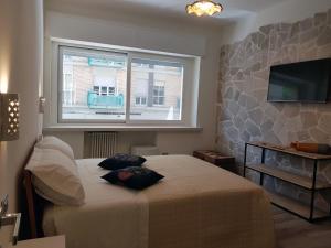 a bedroom with a bed with two pillows on it at RosAmar in Bari