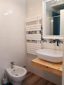 a bathroom with a sink and a toilet and a mirror at RosAmar in Bari