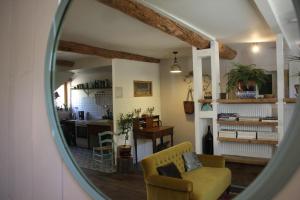 a mirror reflection of a living room with a couch at L'itinérante in Le Somail +66 photos