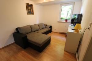 a living room with a couch and a table at Ferienwohnung Both in Wernigerode +3 photos
