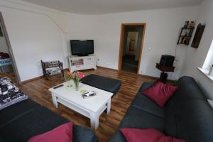 a living room with a couch and a table at Ferienwohnung Both in Wernigerode