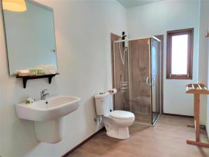 a bathroom with a toilet and a sink and a shower at Armonia Village Resort and Spa in Chumphon