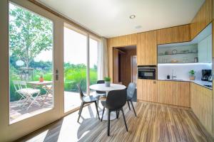 a kitchen and dining room with a table and chairs at NEDOMEK in Neslovice