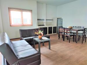 a living room with a couch and a table at Armonia Village Resort and Spa in Chumphon