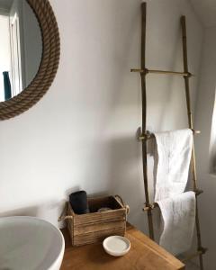 a bathroom with a sink and a mirror and a wooden table at Casa Mediterana in 2 Mai +103 photos
