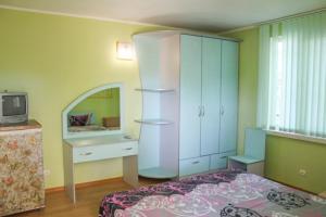 a bedroom with a bed and a cabinet and a tv at Guest House 1279 in Zatoka