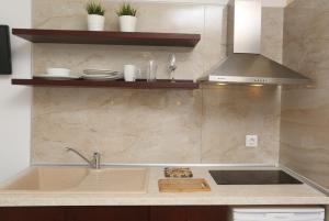 a kitchen with a sink and a stove at Villa Magda Maria in Pefkochori +61 photos