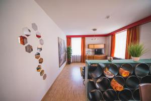 a room with a wall with a shelf with bowls at Dolomitenmannapartments in Lienz