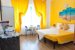 a bedroom with a bed and a yellow wall at Stella Marina in Camogli