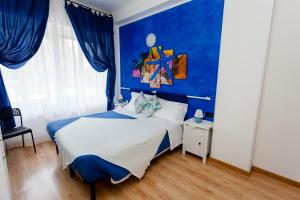 a blue bedroom with a bed and a blue wall at Stella Marina in Camogli