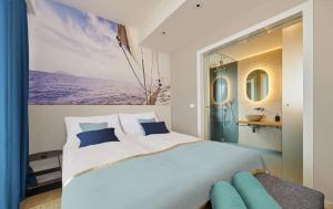 a bedroom with a large white bed and a bathroom at Ribarska Koliba Resort in Pula +37 photos