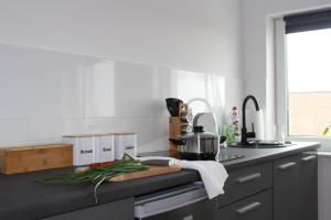 a kitchen with a counter top with vegetables on it at Apartament Kliwia in Tolkmicko