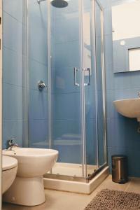 a bathroom with a shower and a toilet and a sink at La finestra "sul Lago" in Predore +23 photos