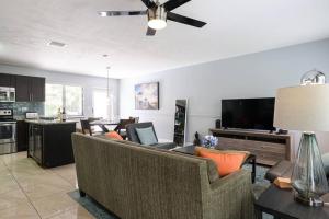 a living room with a couch and a tv at Paradise Home 3 BR with Heated Pool close to Beach in Fort Lauderdale