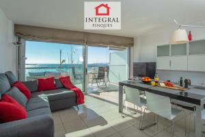 a living room with a couch and a table at Palamós BeachFront Apartment in Palamós
