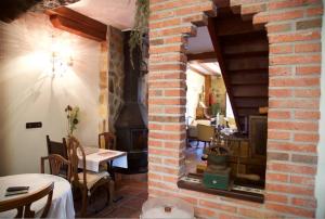 a room with a brick wall with a wood stove at Posada de Seña in Seña