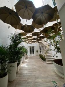a hallway with umbrellas hanging from the ceiling at Le casette di Elen in Marsala