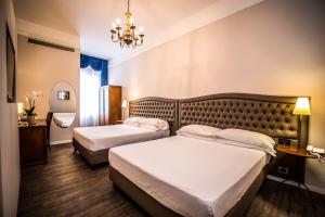 Letto o letti in una camera di Hotel Ristorante Ala d'Oro