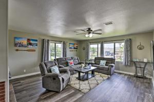 a living room with two couches and a ceiling fan at Spacious and Modern Family Duplex in Galveston! in Galveston