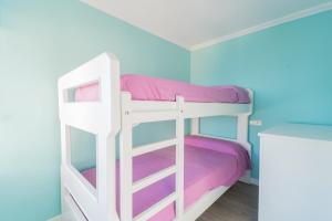 a bunk bed in a room with purple and blue at Expoholidays - Isla Azores in Aguadulce