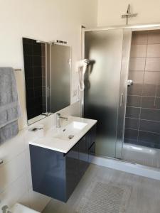 a bathroom with a sink and a shower at Affittacamere Alisso in Olbia
