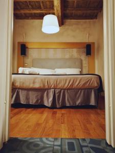 a bed in a bedroom with a light above it at Dulcis In Pantheon in Rome