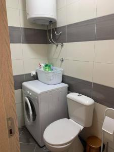 a bathroom with a toilet and a washing machine at Apartment All Seasons in Ulcinj +19 photos