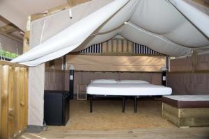 a bedroom with a bed under a tent at Camping Laguna Village in Caorle