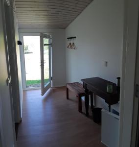 a room with a table and a door with a window at Karens Bakke 2 in Glesborg