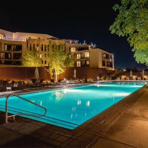 a large blue swimming pool at night at Hotel Chaco in Albuquerque