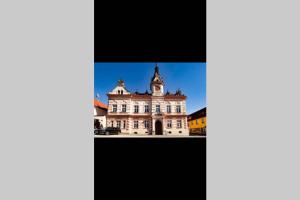 a picture of a building with a blue sky in the background at Zámecký apartmán v Horní Plané in Horní Planá