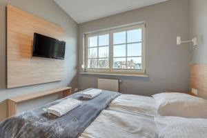 Posteľ alebo postele v izbe v ubytovaní Grand Apartments