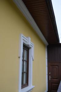 a small white building with a blue door at Brama Ruska in Kamianets-Podilskyi