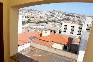 a view of a city from a building with red roofs at Hotel e Restaurante Champagne in Campo Belo