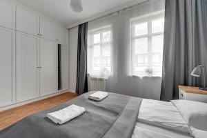 Posteľ alebo postele v izbe v ubytovaní Grand Apartments